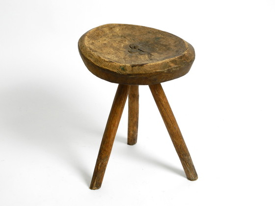 Image 1 of Beautiful 1900s hand-carved three-legged solid wood stool with a fantastic patina