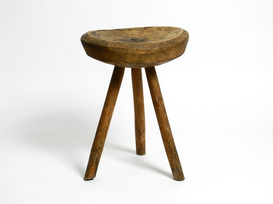 Image 1 of Beautiful 1900s hand-carved three-legged solid wood stool with a fantastic patina