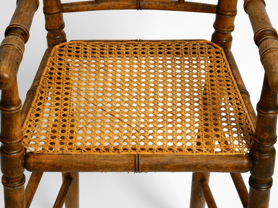 Image 1 of French highchair for a child from the 1930s made of bentwood with Viennese wicker seat