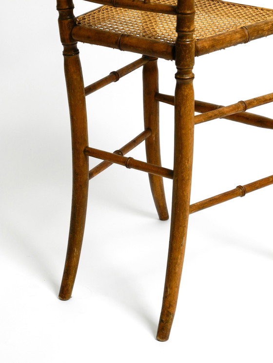 Image 1 of French highchair for a child from the 1930s made of bentwood with Viennese wicker seat