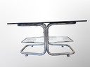 Mesa de centro especial con bases cromadas y tablero de cristal ahumado marrón