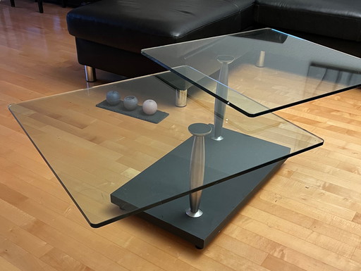 Modern coffee table made of solid, rotating Glass