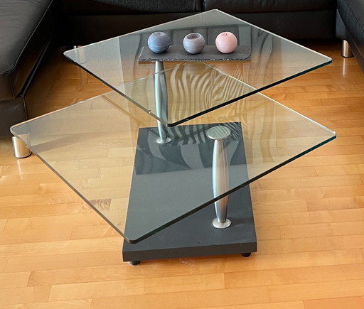 Modern coffee table made of solid, rotating Glass