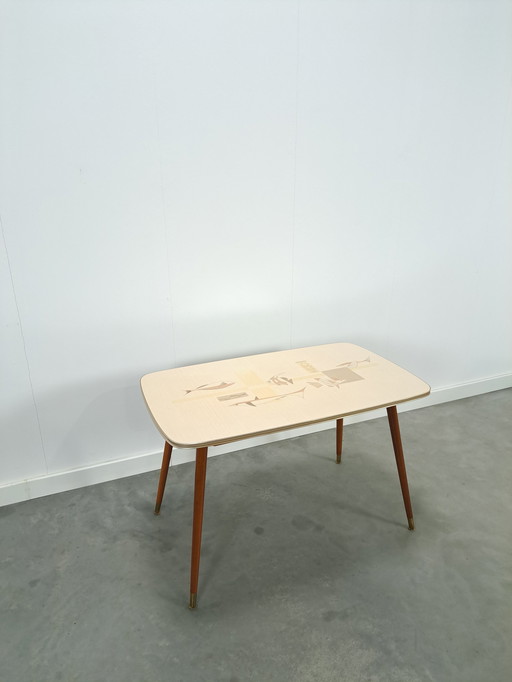 Formica coffee table with brass legs and fish