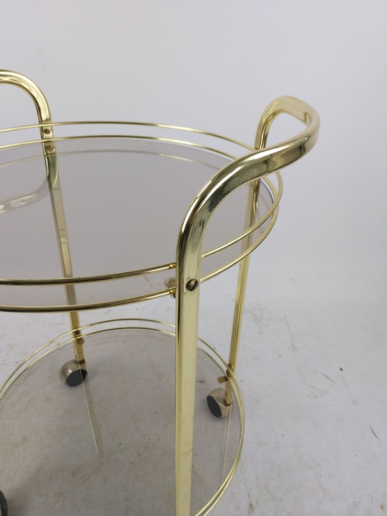 Image 1 of 1 x gold plated beverage trolley 1970's. Smoke glass