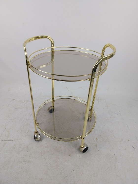 Image 1 of 1 x gold plated beverage trolley 1970's. Smoke glass