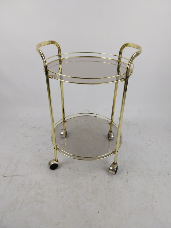 Image 1 of 1 x gold plated beverage trolley 1970's. Smoke glass