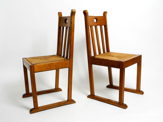 Image 1 of A pair of Mid Century oak chairs with skid feet and wicker seats