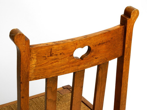 Image 1 of A pair of Mid Century oak chairs with skid feet and wicker seats