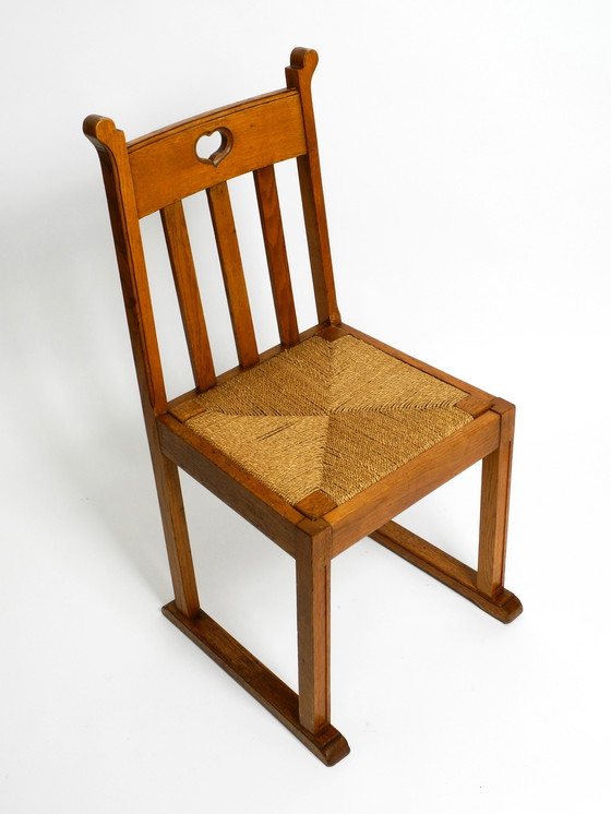 Image 1 of A pair of Mid Century oak chairs with skid feet and wicker seats