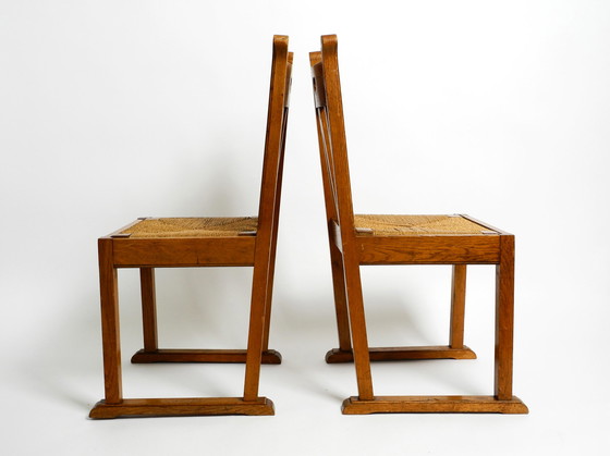 Image 1 of A pair of Mid Century oak chairs with skid feet and wicker seats