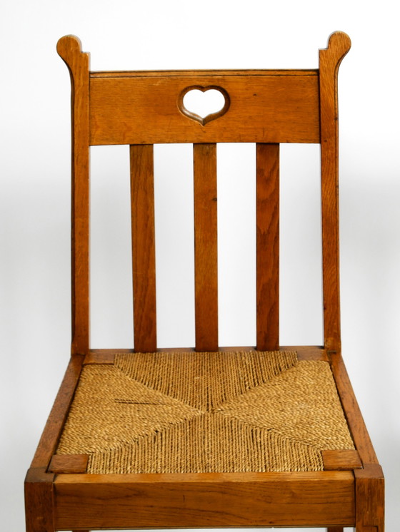 Image 1 of A pair of Mid Century oak chairs with skid feet and wicker seats