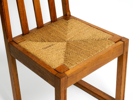 Image 1 of A pair of Mid Century oak chairs with skid feet and wicker seats