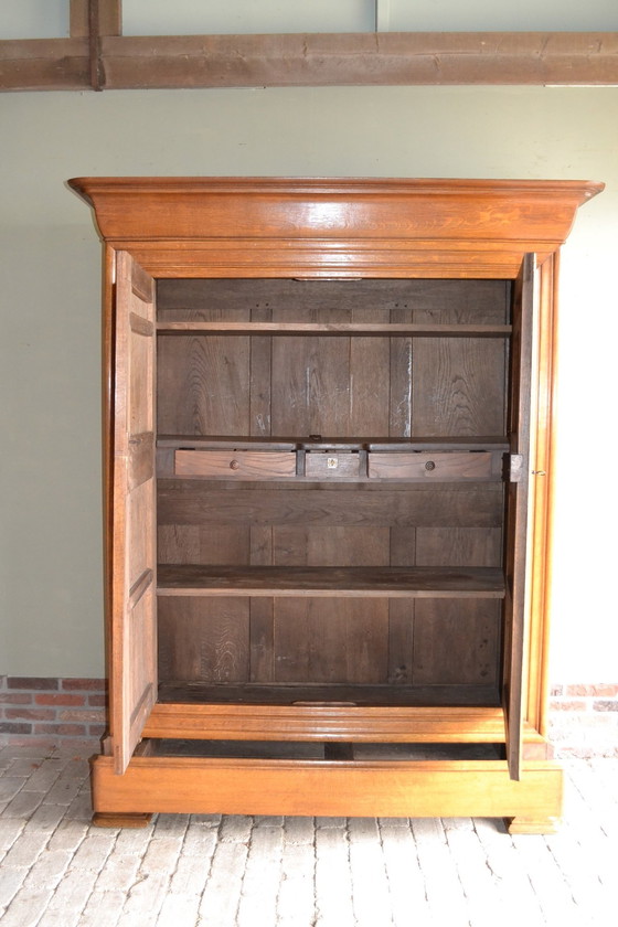 Image 1 of Sleek Antique Oak Louis Philippe Cupboard.