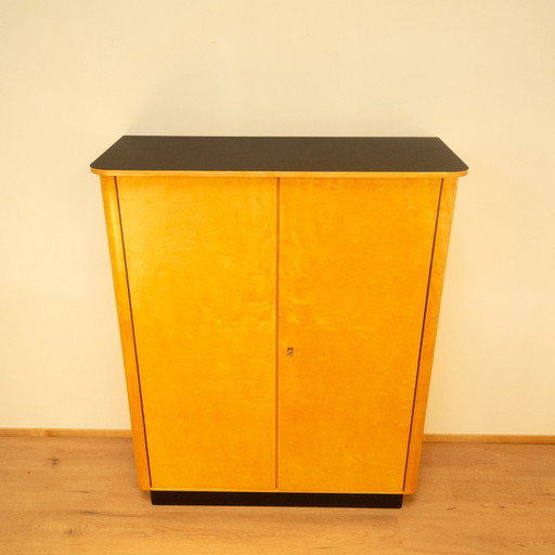 Large chest of drawers, flamed birch with black formica top, 1950s