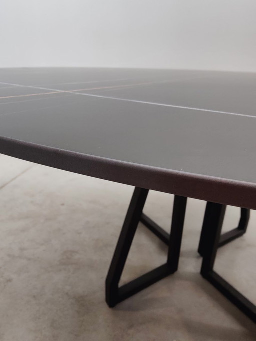 Round dining table with black ceramic top