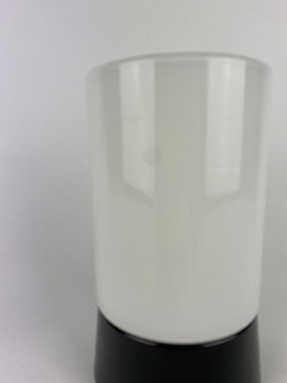 Image 1 of White cylindrical Art Deco Raak ceiling lamp with black fixture.