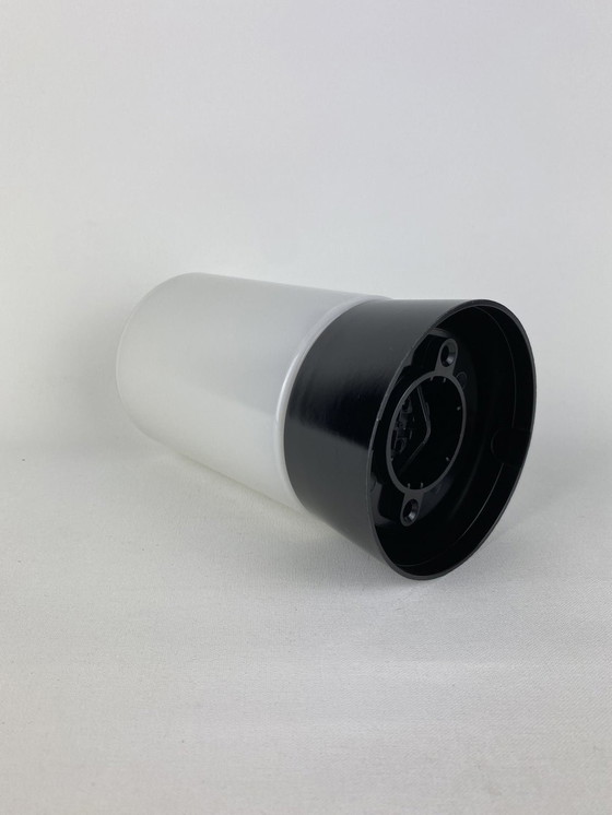 Image 1 of White cylindrical Art Deco Raak ceiling lamp with black fixture.