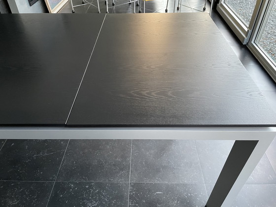 Image 1 of Arco graphic extendable table with wooden top and aluminum legs.