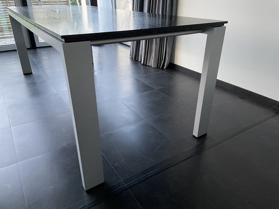 Image 1 of Arco graphic extendable table with wooden top and aluminum legs.