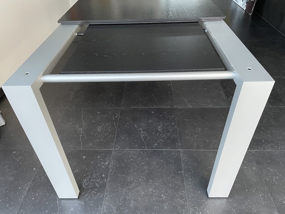 Image 1 of Arco graphic extendable table with wooden top and aluminum legs.