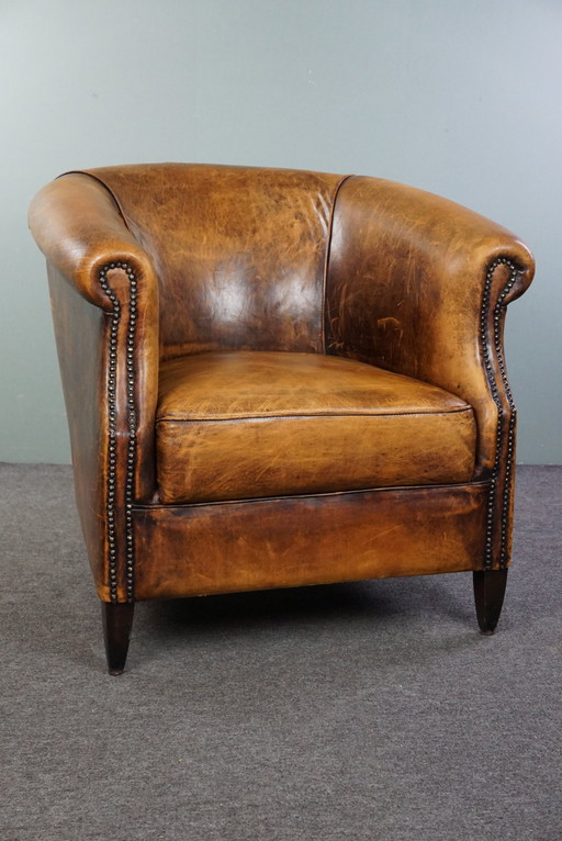 Sheep leather club armchair with signs of wear