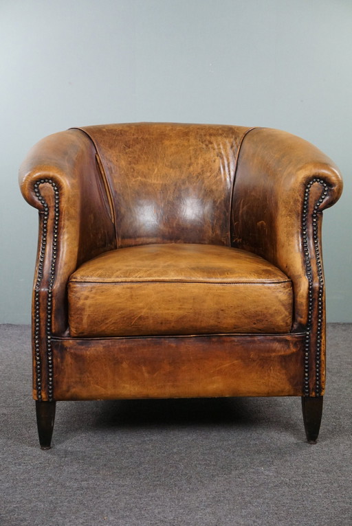 Sheep leather club armchair with signs of wear