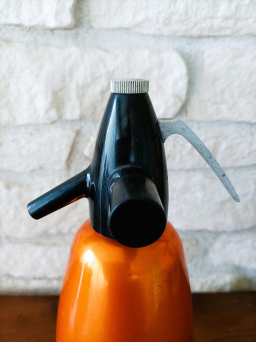 Orange antique siphon