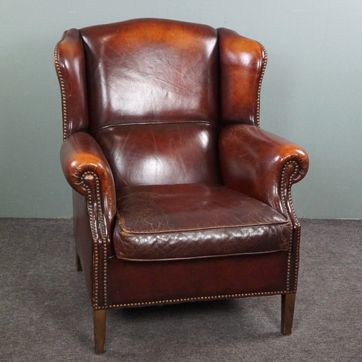 Warm brown sheepskin leather wing chair