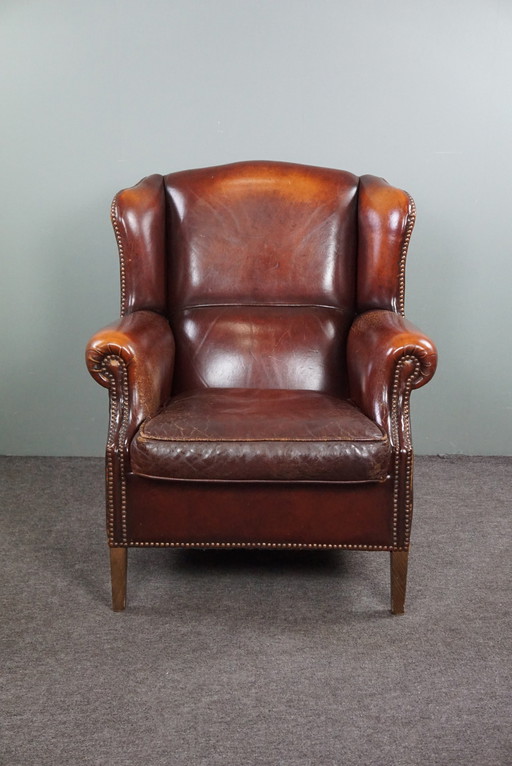 Warm brown sheepskin leather wing chair