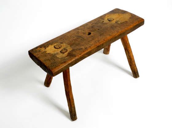 Image 1 of Oblong four-legged original Mid Century solid wood stool with a gorgeous patina