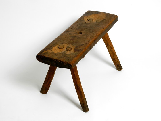 Image 1 of Oblong four-legged original Mid Century solid wood stool with a gorgeous patina