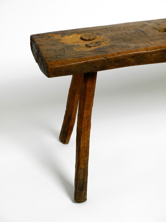 Image 1 of Oblong four-legged original Mid Century solid wood stool with a gorgeous patina