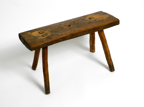 Image 1 of Oblong four-legged original Mid Century solid wood stool with a gorgeous patina