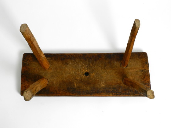 Image 1 of Oblong four-legged original Mid Century solid wood stool with a gorgeous patina