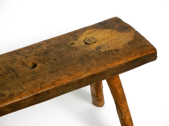 Image 1 of Oblong four-legged original Mid Century solid wood stool with a gorgeous patina