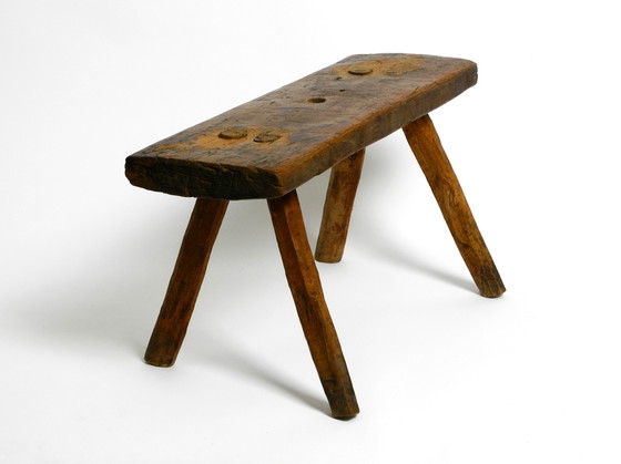 Image 1 of Oblong four-legged original Mid Century solid wood stool with a gorgeous patina