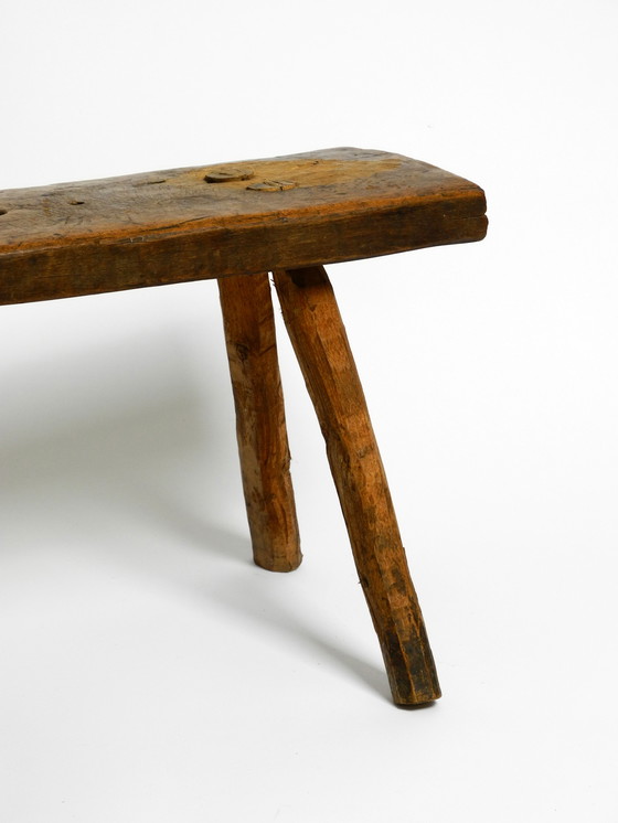 Image 1 of Oblong four-legged original Mid Century solid wood stool with a gorgeous patina