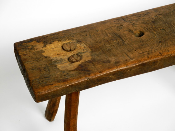 Image 1 of Oblong four-legged original Mid Century solid wood stool with a gorgeous patina