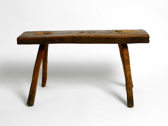 Image 1 of Oblong four-legged original Mid Century solid wood stool with a gorgeous patina