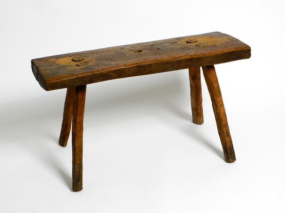 Image 1 of Oblong four-legged original Mid Century solid wood stool with a gorgeous patina