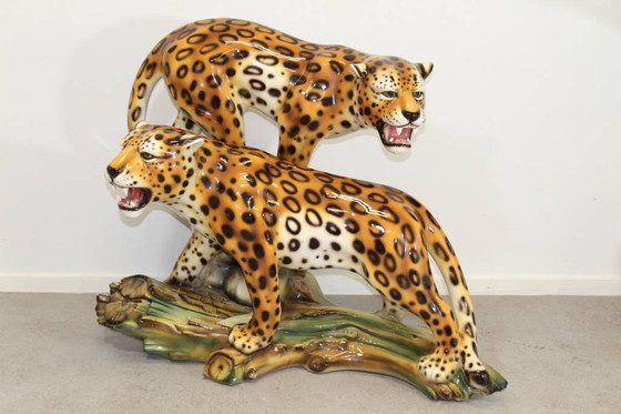 Image 1 of Ceramic leopards on tree trunk