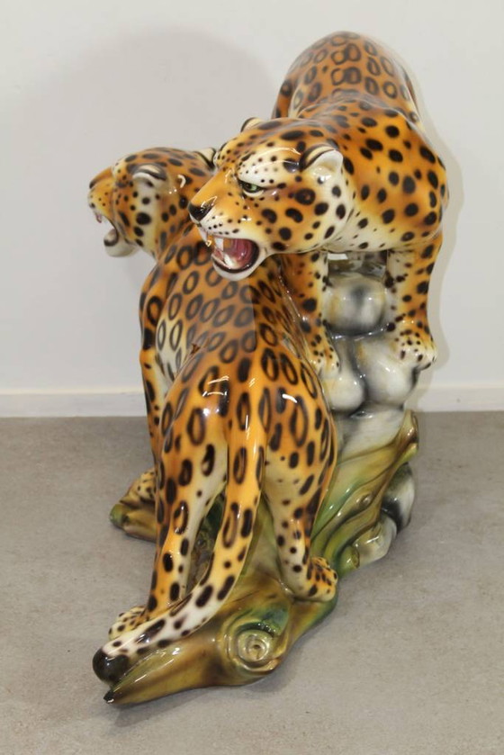 Image 1 of Ceramic leopards on tree trunk