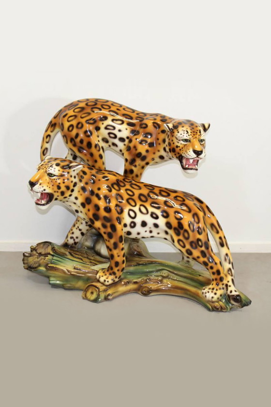 Image 1 of Ceramic leopards on tree trunk