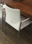 6x Modern white leather dining chairs with chrome tubular frame.
