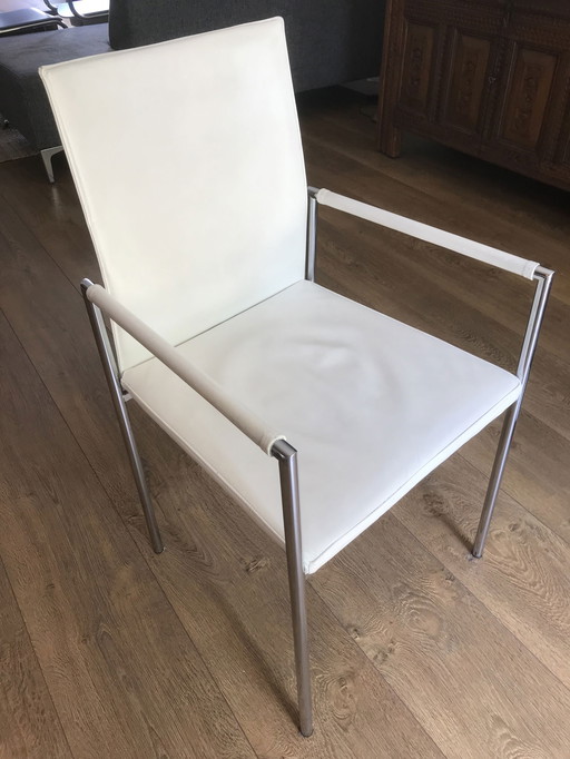 6x Modern white leather dining chairs with chrome tubular frame.