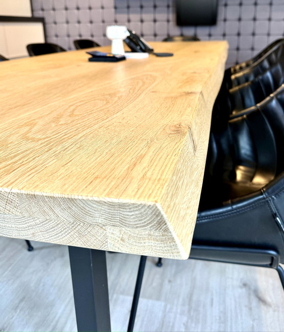 Image 1 of Dining table with oak tree trunk top on metal U-leg