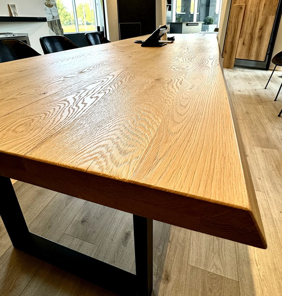 Image 1 of Dining table with oak tree trunk top on metal U-leg