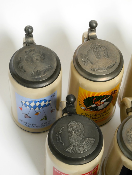 Image 1 of Nine unused original Munich Oktoberfest beer Pitchers with heavy tin lids from 2001 - 2009