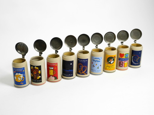 Nine unused original Munich Oktoberfest beer Pitchers with heavy tin lids from 2001 - 2009